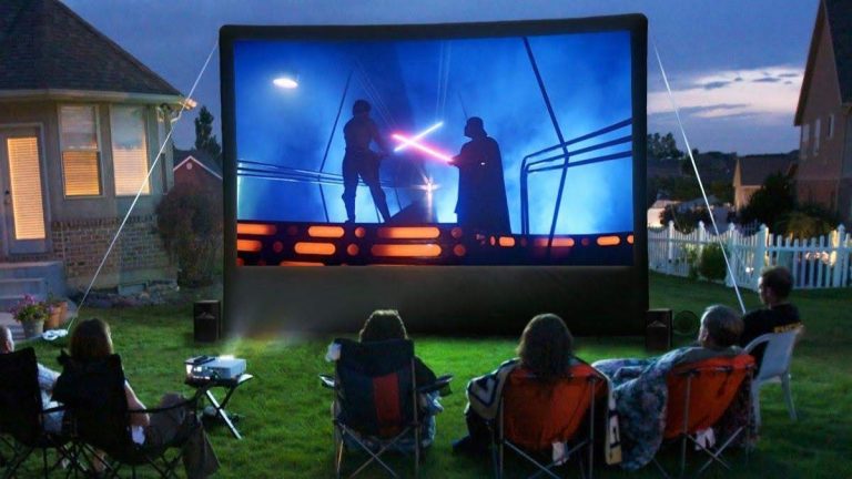 An outdoors projector displaying Star Wars