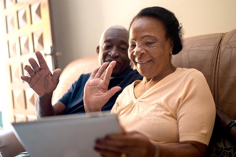 Couple using digital tablet connected to broadband