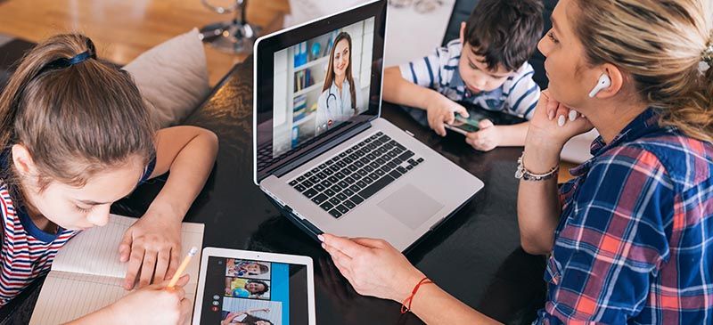 Family using devices to work and do homework online