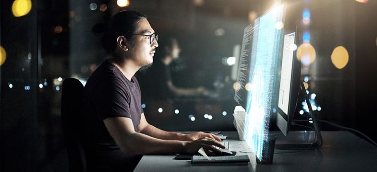 Cropped shot of a male computer programmer working late on the computer doing coding