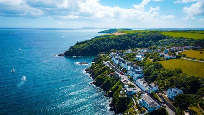 A birds eye view of some houses overlooking the sea in Cornwall.