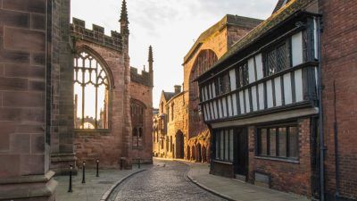 A windy, cobbled street in Coventry next to the cathedral