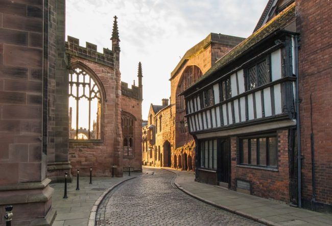 A windy, cobbled street in Coventry next to the cathedral